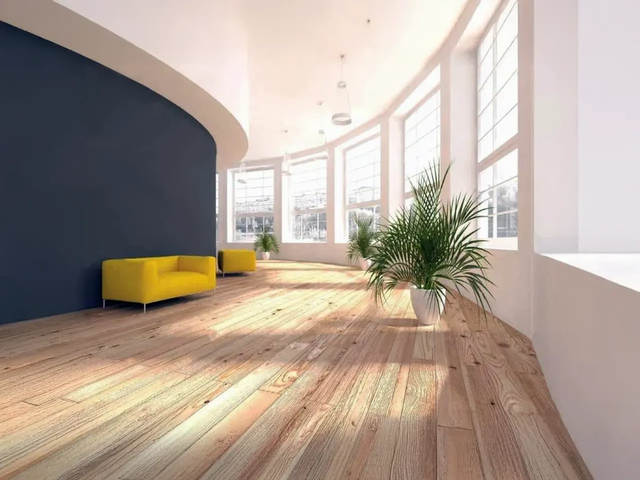 Espace de bureaux moderne avec fauteuils jaunes design le long d'un mur courbe bleu marine